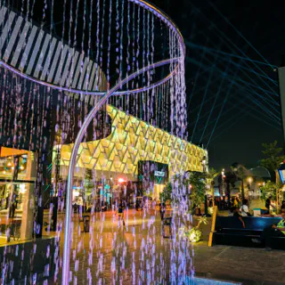 Colorful fountain in front of a lit building